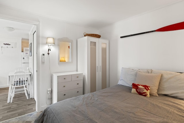 168 Shore Rd Unit 5, Truro, MA 02666 - bedroom with ornamental molding, wood finished floors, and freestanding refrigerator