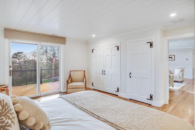 bedroom with recessed lighting, crown molding, two closets, wood finished floors, and access to exterior