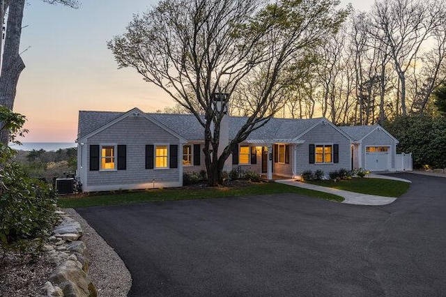 view of front of property with cooling unit, driveway, and an attached garage