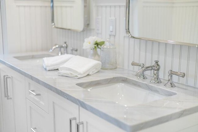 full bathroom featuring double vanity and a sink