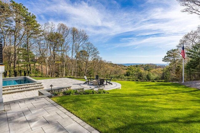 view of home's community featuring an outdoor fire pit, a patio area, a swimming pool, and a yard