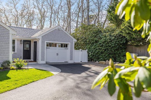 garage with driveway and fence