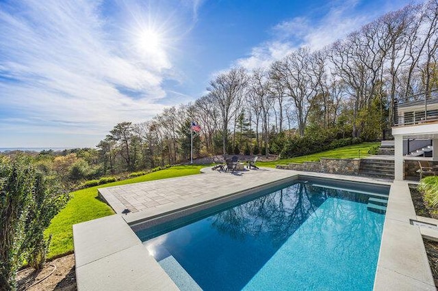pool with a lawn and a patio