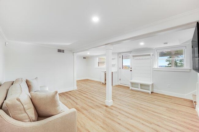 living room featuring light wood-style flooring, recessed lighting, visible vents, decorative columns, and crown molding