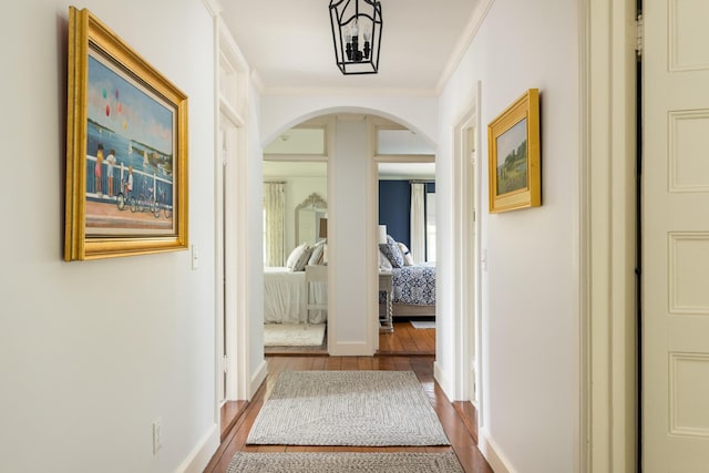 150 Sea View Ave, Osterville, MA 02655 - corridor featuring baseboards, wood finished floors, arched walkways, and ornamental molding