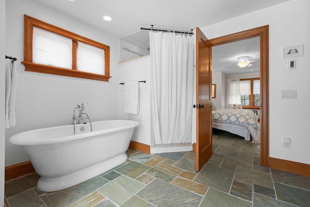 40 Leilla Rich Dr, Wellfleet, MA 02667 - ensuite bathroom with stone tile floors, baseboards, curtained shower, a freestanding tub, and recessed lighting