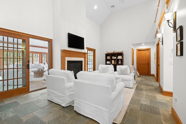 40 Leilla Rich Dr, Wellfleet, MA 02667 - living area featuring high vaulted ceiling, stone tile floors, baseboards, a glass covered fireplace, and recessed lighting