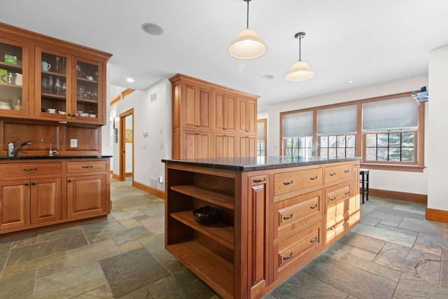 40 Leilla Rich Dr, Wellfleet, MA 02667 - kitchen with stone tile flooring, baseboards, a sink, open shelves, and dark countertops