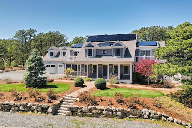40 Leilla Rich Dr, Wellfleet, MA 02667 - shingle-style home with a porch, roof mounted solar panels, a garage, and driveway