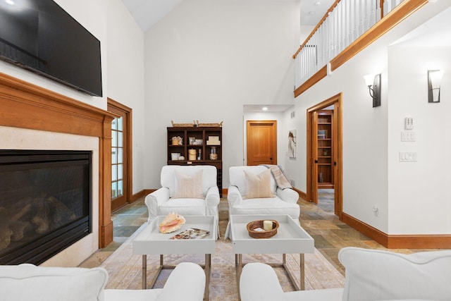 40 Leilla Rich Dr, Wellfleet, MA 02667 - living area with stone tile flooring, baseboards, high vaulted ceiling, and a premium fireplace