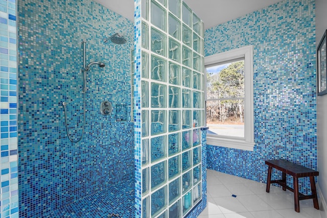 bathroom featuring a walk in shower, a healthy amount of sunlight, tile walls, and tile patterned floors