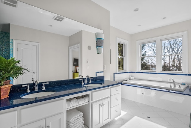 bathroom featuring tile patterned floors, visible vents, a sink, and double vanity