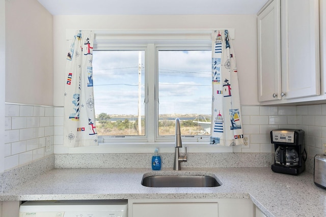 496 Shore Rd Unit 4, Truro, MA 02666 - kitchen featuring a sink, dishwasher, backsplash, white cabinets, and light stone countertops