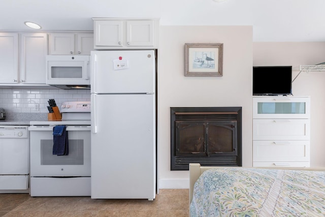 496 Shore Rd Unit 4, Truro, MA 02666 - kitchen with white appliances, white cabinetry, and decorative backsplash