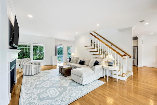 780 Craigville Beach Rd Unit 10, Centerville, MA 02632 - living room with stairway, a fireplace, light wood finished floors, crown molding, and recessed lighting