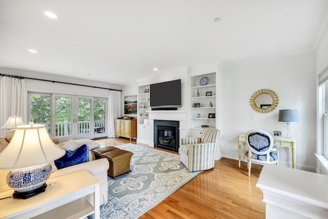 780 Craigville Beach Rd Unit 10, Centerville, MA 02632 - living area featuring crown molding, a glass covered fireplace, light wood finished floors, recessed lighting, and french doors
