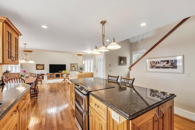 86 Summersea Rd, Mashpee, MA 02649 - kitchen featuring light wood-style flooring, a wealth of natural light, glass insert cabinets, and double oven range