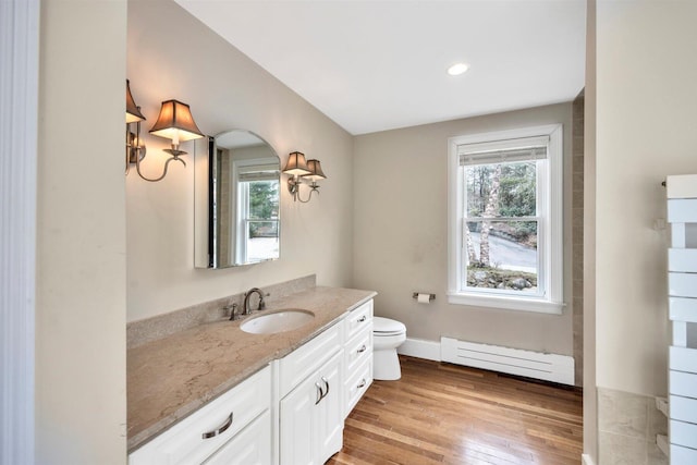 86 Summersea Rd, Mashpee, MA 02649 - bathroom featuring wood finished floors, a baseboard radiator, toilet, vanity, and baseboards