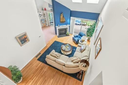 3 Mayfair Ct, Mashpee, MA 02649 - living area with wood finished floors and a fireplace with flush hearth