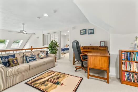 3 Mayfair Ct, Mashpee, MA 02649 - office with ceiling fan, a skylight, carpet, and lofted ceiling