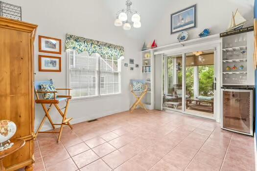 3 Mayfair Ct, Mashpee, MA 02649 - unfurnished dining area with tile patterned flooring, a chandelier, and high vaulted ceiling