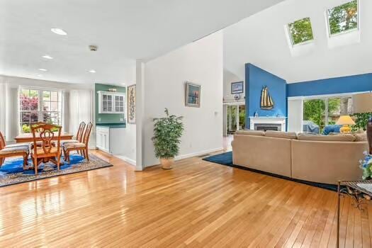 3 Mayfair Ct, Mashpee, MA 02649 - living area with hardwood / wood-style floors, a fireplace, a skylight, and recessed lighting
