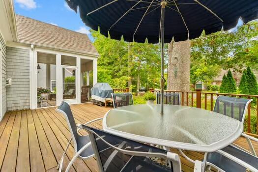 3 Mayfair Ct, Mashpee, MA 02649 - wooden deck with outdoor dining space and a sunroom