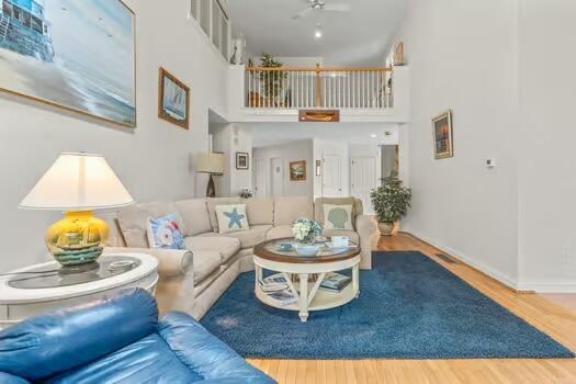 3 Mayfair Ct, Mashpee, MA 02649 - living area with wood finished floors, ceiling fan, and a high ceiling