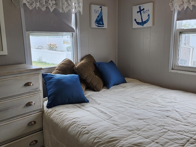 bedroom with wood walls