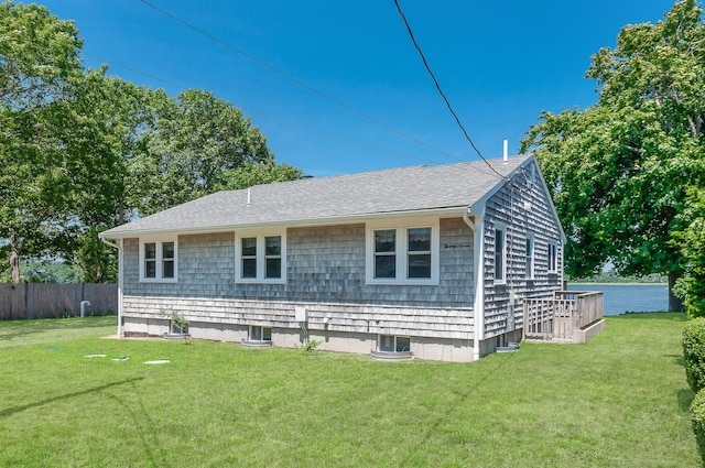 back of property with cooling unit, a wooden deck, and a yard