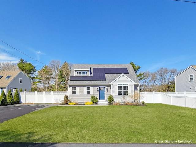 view of front of property featuring solar panels and a shingled roof