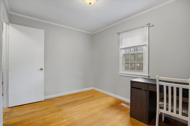 unfurnished bedroom with light wood finished floors, baseboards, and crown molding