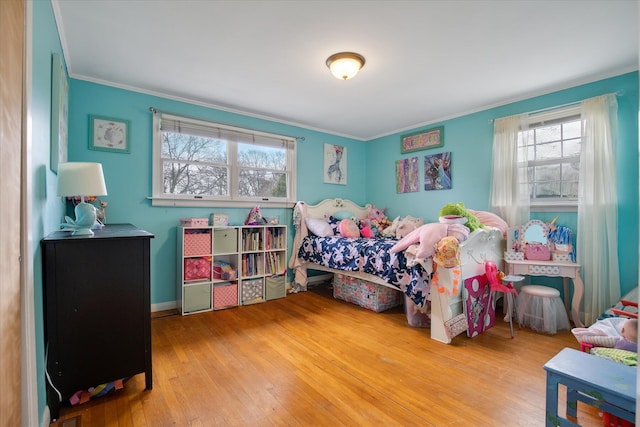 bedroom with hardwood / wood-style flooring and crown molding