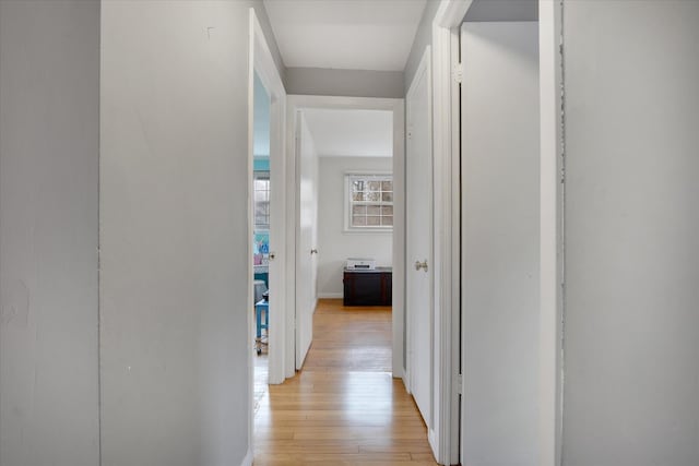 corridor featuring light wood finished floors