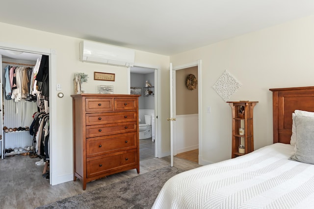 bedroom featuring a closet and a wall mounted AC