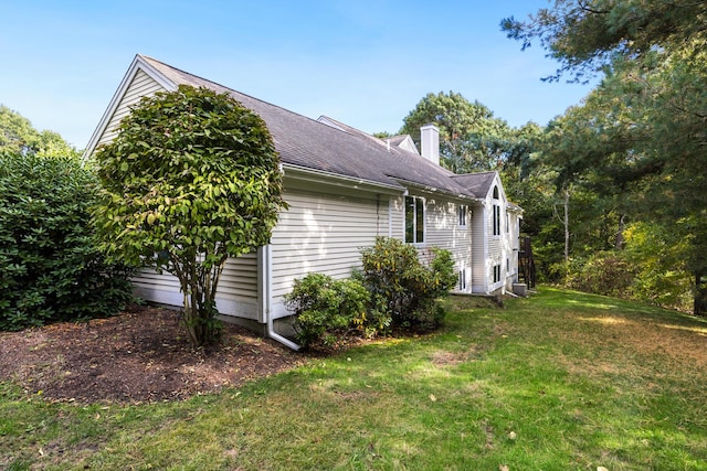 view of side of home featuring a yard