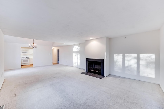 unfurnished living room featuring recessed lighting, a notable chandelier, a multi sided fireplace, and light colored carpet