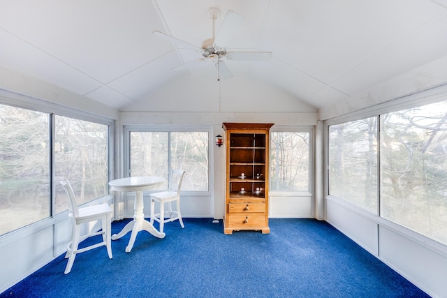 sunroom / solarium with a ceiling fan and vaulted ceiling