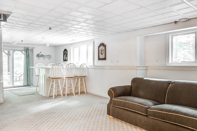 interior space featuring a bar and baseboards