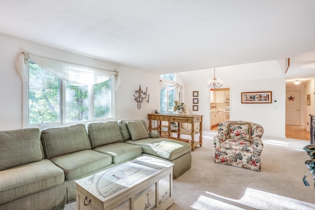 living room featuring light colored carpet and a chandelier