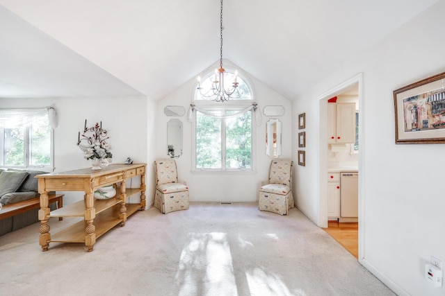 living area featuring lofted ceiling, light carpet, and an inviting chandelier