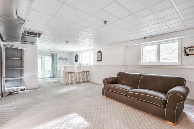 carpeted living room featuring bar