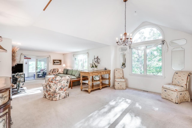 sitting room featuring a chandelier, a healthy amount of sunlight, light carpet, and lofted ceiling