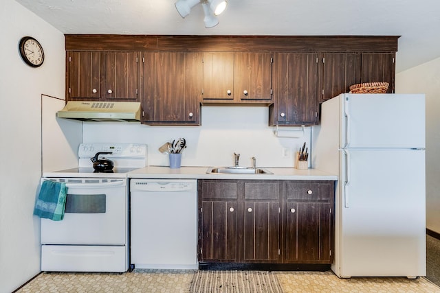 kitchen featuring white appliances, dark brown cabinetry, and sink