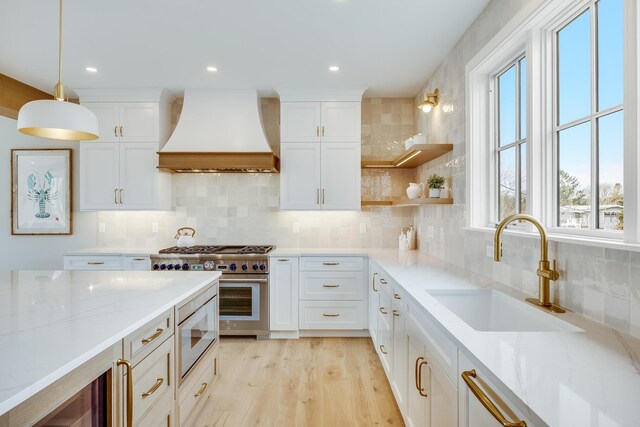 179 Beebe Acres Rd, Falmouth, MA 02540 - kitchen with built in microwave, a sink, stainless steel stove, tasteful backsplash, and custom exhaust hood