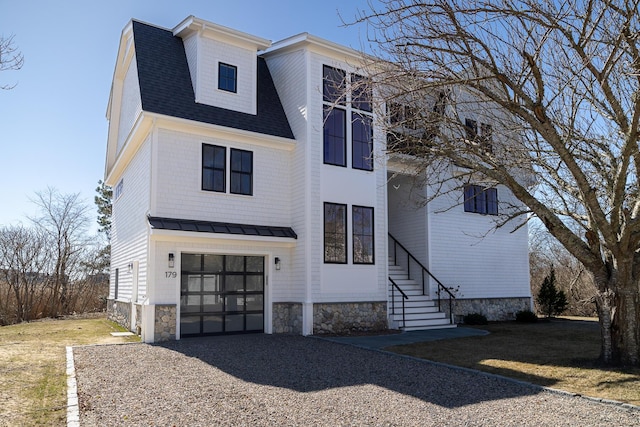 179 Beebe Acres Rd, Falmouth, MA 02540 - view of front of home featuring roof with shingles, a standing seam roof, metal roof, a garage, and gravel driveway