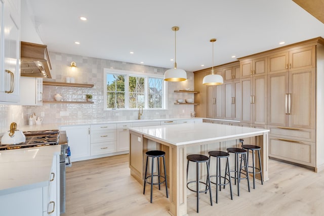 179 Beebe Acres Rd, Falmouth, MA 02540 - kitchen with decorative backsplash, high end stainless steel range, open shelves, and light wood finished floors