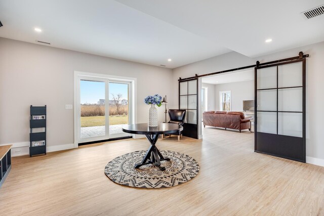 179 Beebe Acres Rd, Falmouth, MA 02540 - interior space with a barn door, plenty of natural light, visible vents, and light wood-type flooring