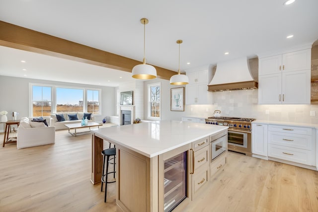 179 Beebe Acres Rd, Falmouth, MA 02540 - kitchen featuring custom exhaust hood, stainless steel appliances, wine cooler, and light wood-style floors