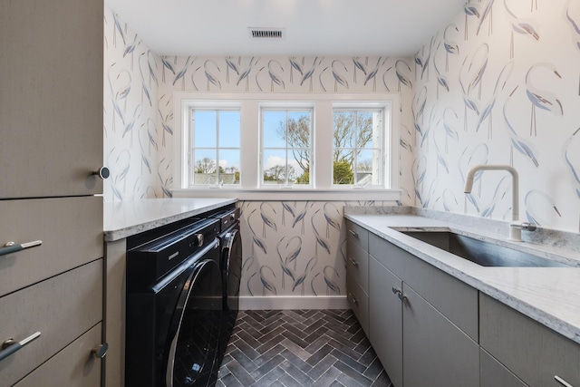 179 Beebe Acres Rd, Falmouth, MA 02540 - laundry area featuring a sink, wallpapered walls, washer / dryer, cabinet space, and visible vents